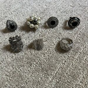 Assorted silver tone and one sterling silver rings, size 6.5-7